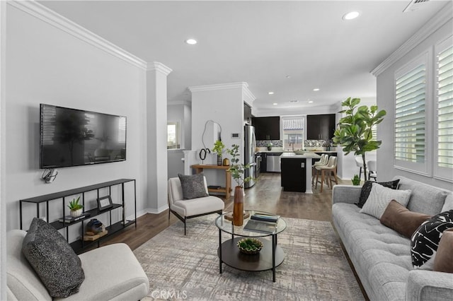 17557 Newland St Unit 101, Huntington Beach, CA 92647 - living room with recessed lighting, ornamental molding, and light wood-type flooring