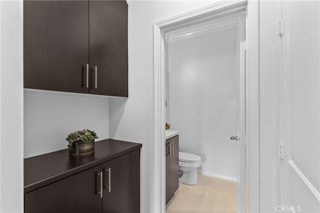 17557 Newland St Unit 101, Huntington Beach, CA 92647 - bathroom featuring toilet and vanity