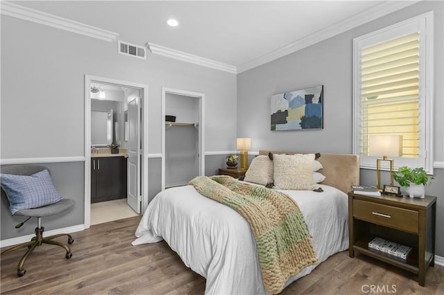 17557 Newland St Unit 101, Huntington Beach, CA 92647 - bedroom with crown molding, wood finished floors, ensuite bathroom, and recessed lighting