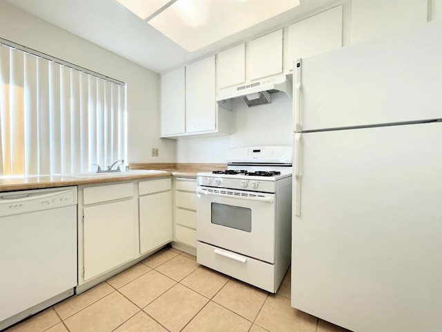 1249 Arcadia Ave, Vista, CA 92084 - kitchen with white appliances, under cabinet range hood, light tile patterned floors, light countertops, and white cabinetry