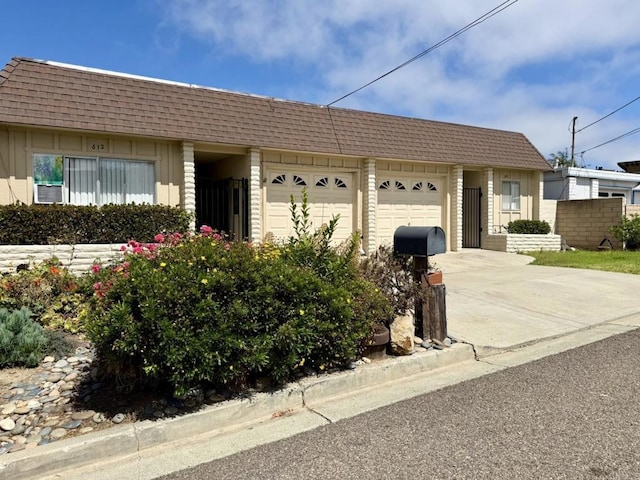60814 Garfield St, Oceanside, CA 92054 - single story home featuring an attached garage, driveway, mansard roof, and a shingled roof