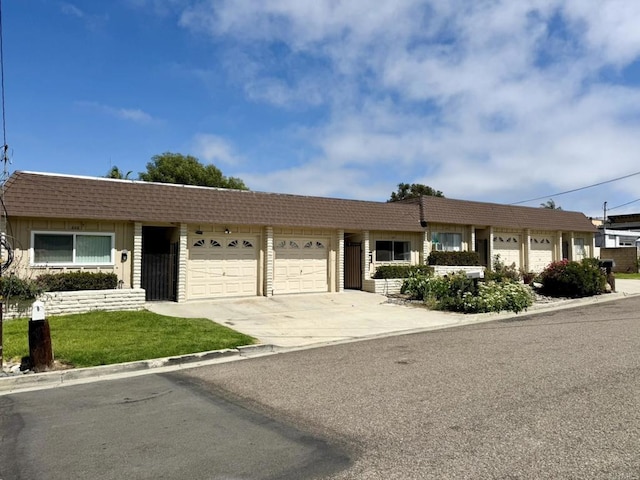 60814 Garfield St, Oceanside, CA 92054 - ranch-style home with a garage, mansard roof, concrete driveway, and a front yard
