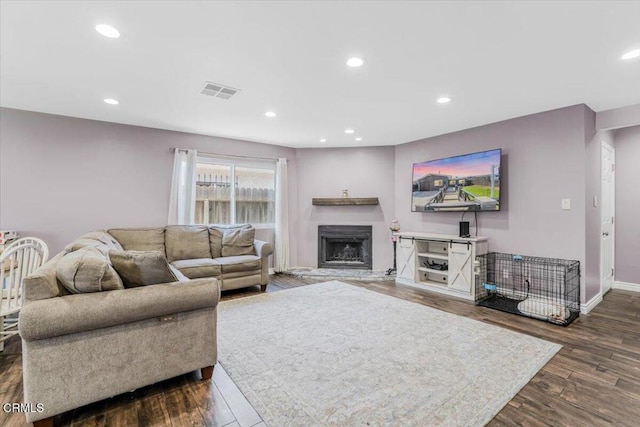 118 Everest St, Oxnard, CA 93030 - living area featuring dark wood finished floors, a fireplace with raised hearth, and recessed lighting