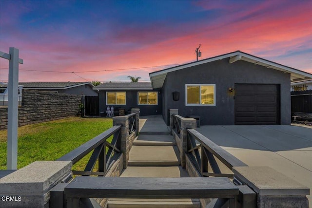 118 Everest St, Oxnard, CA 93030 - view of front of house with a garage, stucco siding, and concrete driveway