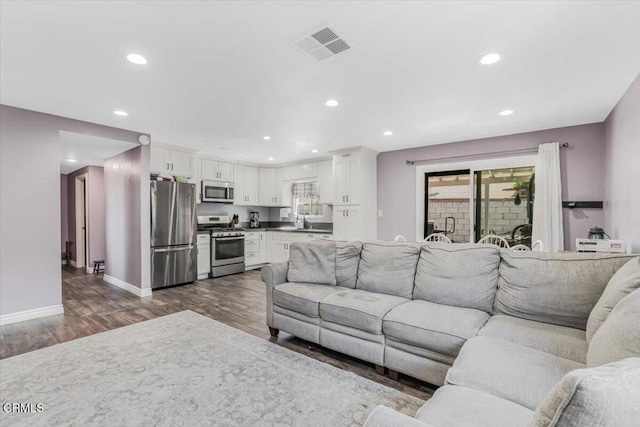 118 Everest St, Oxnard, CA 93030 - living area with recessed lighting, dark wood-style floors, and plenty of natural light
