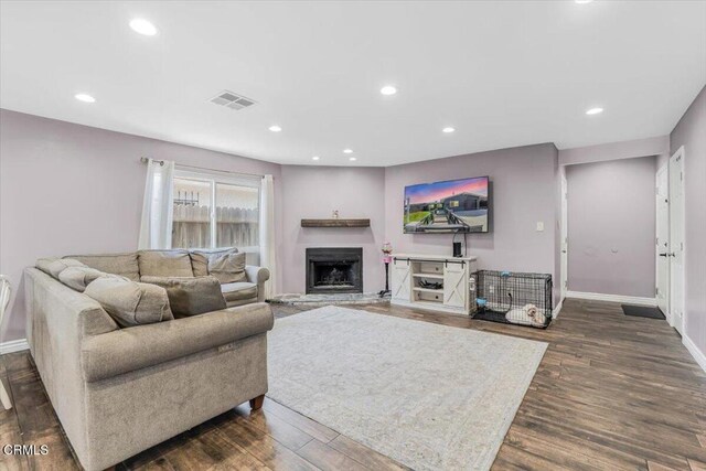 118 Everest St, Oxnard, CA 93030 - living area with dark wood-style floors, recessed lighting, and a fireplace with raised hearth