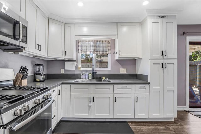 118 Everest St, Oxnard, CA 93030 - kitchen with stainless steel appliances, white cabinets, healthy amount of natural light, recessed lighting, and dark wood finished floors