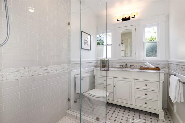 802 S Arroyo Blvd, Pasadena, CA 91105 - bathroom with vanity, a tile shower, tile walls, tile patterned flooring, and a wainscoted wall