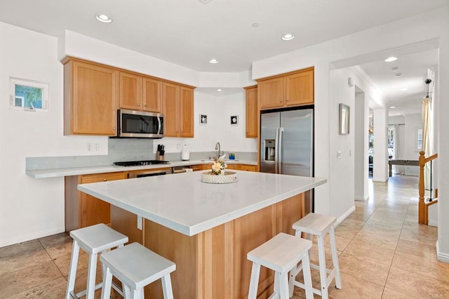 432 S Cleveland St, Oceanside, CA 92054 - kitchen featuring stainless steel appliances, a breakfast bar, light countertops, and recessed lighting