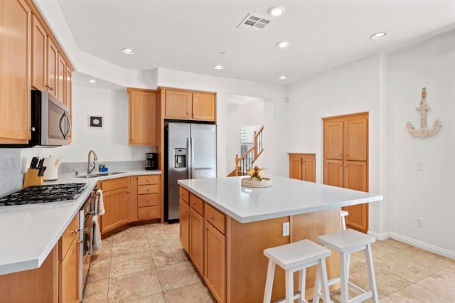 432 S Cleveland St, Oceanside, CA 92054 - kitchen with stainless steel appliances, a breakfast bar area, a kitchen island, light countertops, and recessed lighting