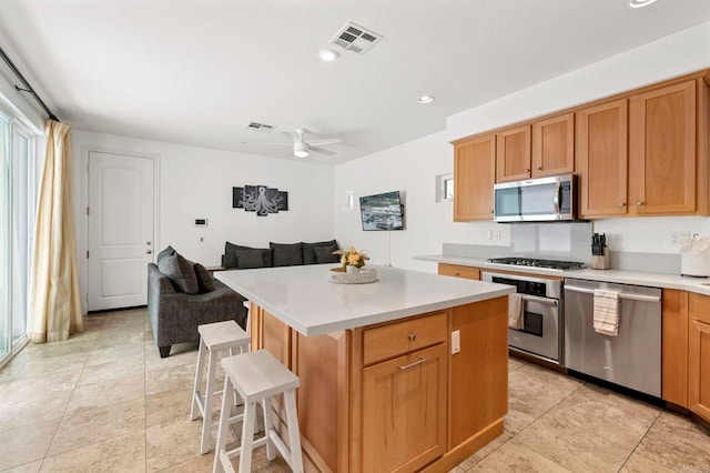 432 S Cleveland St, Oceanside, CA 92054 - kitchen featuring stainless steel appliances, light countertops, a kitchen island, a breakfast bar, and recessed lighting