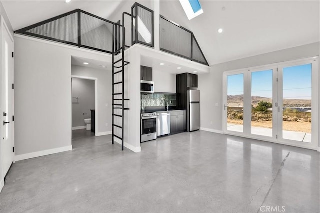 61850 Alta Mura Dr, Joshua Tree, CA 92252 - unfurnished living room with high vaulted ceiling, finished concrete floors, a skylight, and recessed lighting