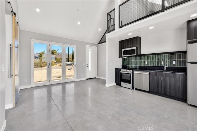 61850 Alta Mura Dr, Joshua Tree, CA 92252 - kitchen featuring appliances with stainless steel finishes, tasteful backsplash, concrete floors, high vaulted ceiling, and recessed lighting