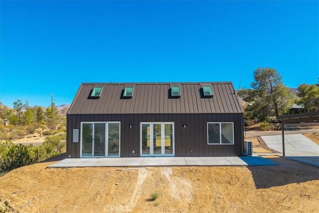 61850 Alta Mura Dr, Joshua Tree, CA 92252 - back of property with a standing seam roof, a patio area, and a metal roof