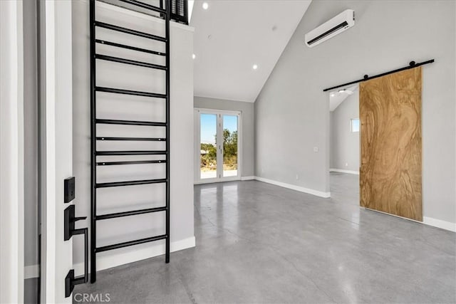 61850 Alta Mura Dr, Joshua Tree, CA 92252 - staircase with a wall unit AC, a barn door, vaulted ceiling, and concrete flooring