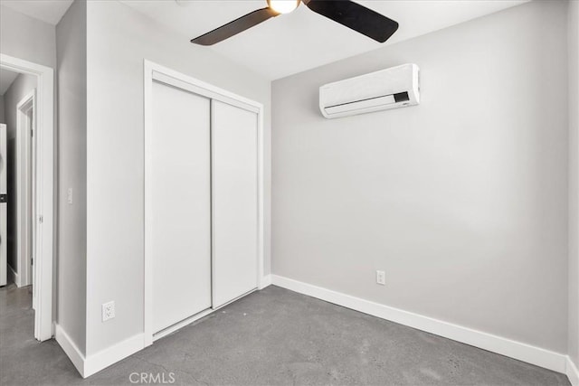 61850 Alta Mura Dr, Joshua Tree, CA 92252 - unfurnished bedroom featuring a wall mounted AC, finished concrete floors, a closet, and ceiling fan
