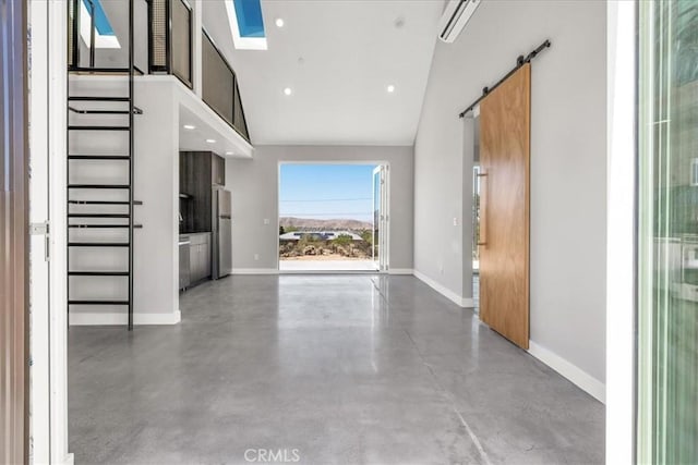 61850 Alta Mura Dr, Joshua Tree, CA 92252 - entryway with concrete floors, a barn door, lofted ceiling, a skylight, and recessed lighting