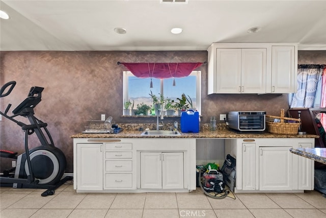 50802 280th St W, Lancaster, CA 93536 - kitchen featuring healthy amount of natural light, white cabinets, light tile patterned flooring, stone counters, and recessed lighting