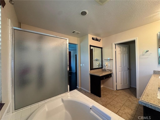 24112 Joshua Dr, Valencia, CA 91354 - full bath featuring vanity, a stall shower, a garden tub, a textured ceiling, and tile patterned flooring