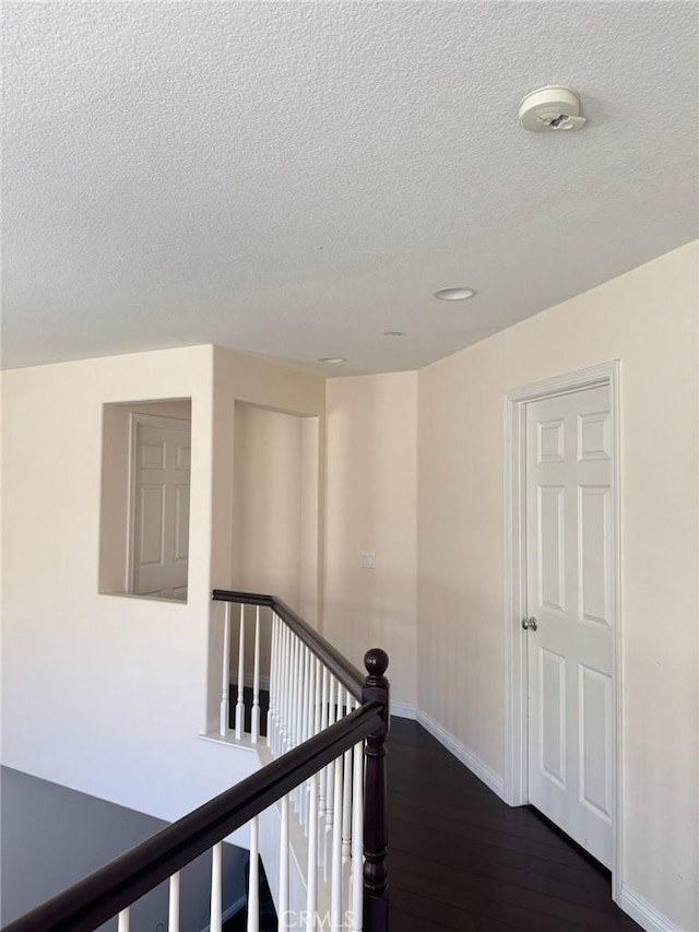 24112 Joshua Dr, Valencia, CA 91354 - hallway with an upstairs landing, a textured ceiling, and dark wood finished floors