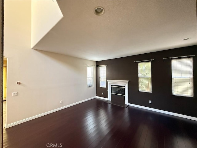 24112 Joshua Dr, Valencia, CA 91354 - unfurnished living room featuring dark wood-style flooring and a glass covered fireplace