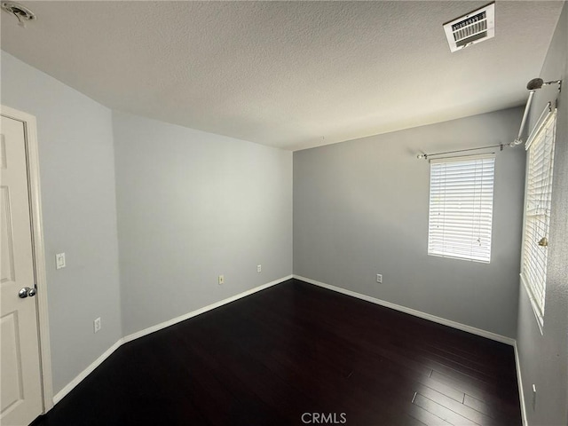 24112 Joshua Dr, Valencia, CA 91354 - spare room featuring dark wood finished floors and a textured ceiling