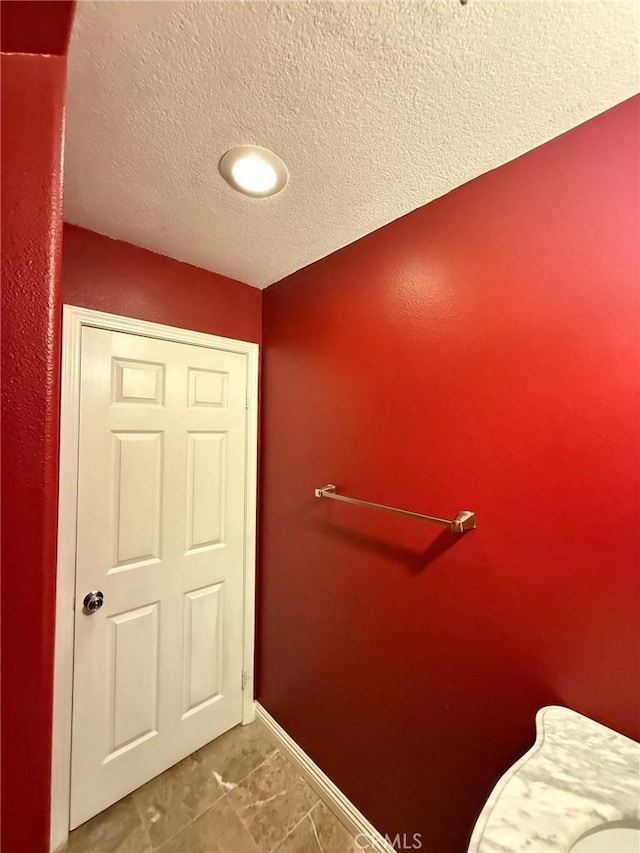 24112 Joshua Dr, Valencia, CA 91354 - bathroom with baseboards and a textured ceiling