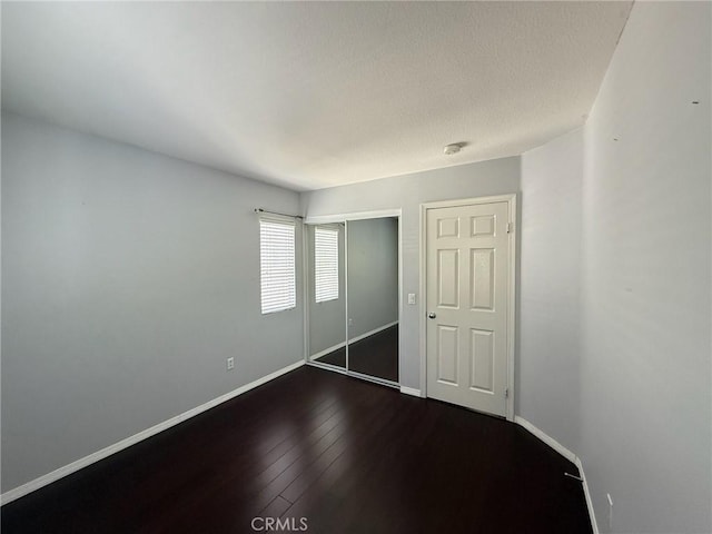 24112 Joshua Dr, Valencia, CA 91354 - unfurnished bedroom featuring dark wood-style flooring, a closet, and a textured ceiling