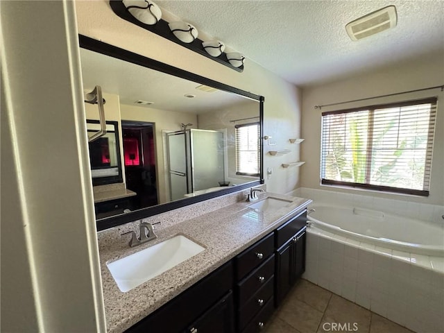24112 Joshua Dr, Valencia, CA 91354 - bathroom featuring a shower stall, a garden tub, tile patterned floors, double vanity, and a textured ceiling