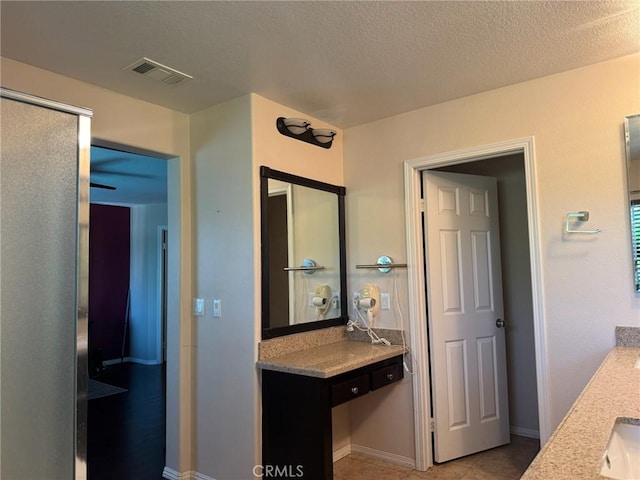 24112 Joshua Dr, Valencia, CA 91354 - full bathroom featuring vanity, tile patterned flooring, and a textured ceiling