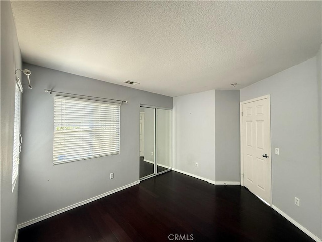 24112 Joshua Dr, Valencia, CA 91354 - unfurnished bedroom with wood finished floors, a textured ceiling, and a closet