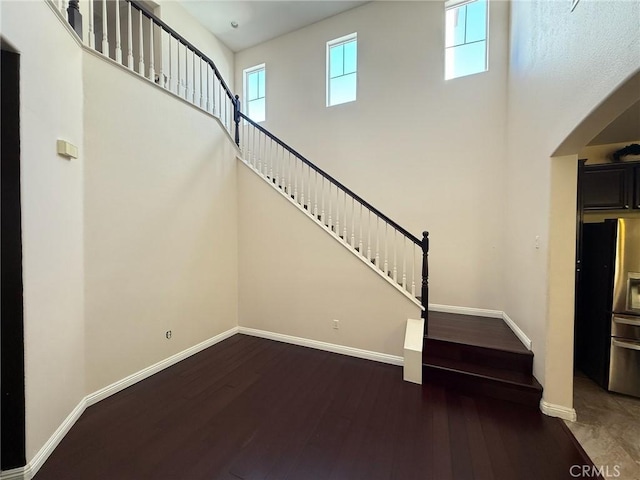 24112 Joshua Dr, Valencia, CA 91354 - stairway featuring wood finished floors and a towering ceiling