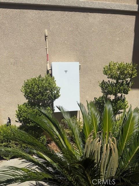 24112 Joshua Dr, Valencia, CA 91354 - exterior view of stucco siding and a power storage unit