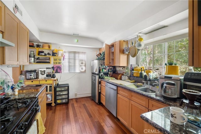 2511 W 5th St, Los Angeles, CA 90057 - kitchen with appliances with stainless steel finishes, dark wood finished floors, dark stone counters, and brown cabinetry