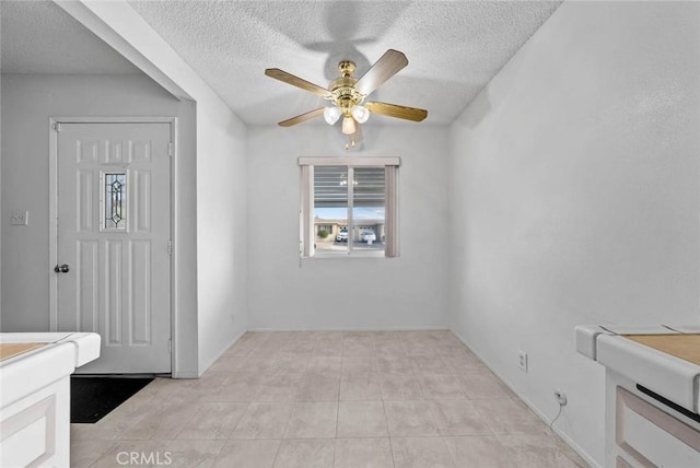 3648 Mira Pacific Dr, Oceanside, CA 92056 - unfurnished dining area with ceiling fan, a textured ceiling, and light tile patterned floors