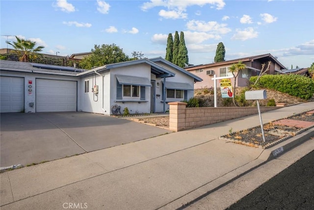3648 Mira Pacific Dr, Oceanside, CA 92056 - view of front of home with roof mounted solar panels, driveway, stucco siding, and a garage