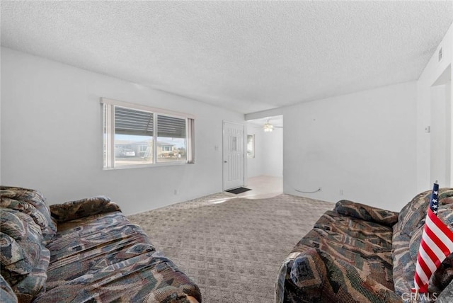 3648 Mira Pacific Dr, Oceanside, CA 92056 - living area with carpet, a textured ceiling, and ceiling fan
