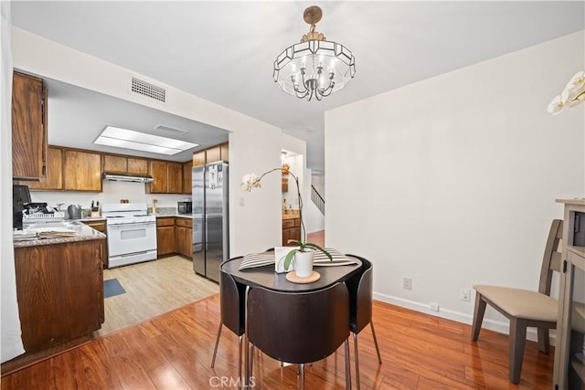 2608 W Grand Ave Unit B, Alhambra, CA 91801 - dining area with light wood-type flooring and a chandelier