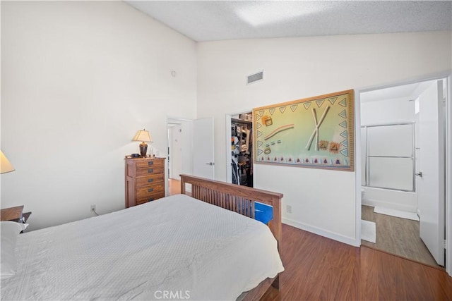 2608 W Grand Ave Unit B, Alhambra, CA 91801 - bedroom featuring wood finished floors, a spacious closet, high vaulted ceiling, and a textured ceiling