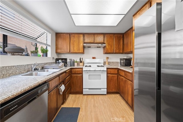 2608 W Grand Ave Unit B, Alhambra, CA 91801 - kitchen featuring stainless steel appliances, brown cabinetry, light wood-style flooring, and under cabinet range hood
