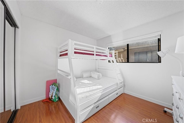 2608 W Grand Ave Unit B, Alhambra, CA 91801 - bedroom featuring light wood-type flooring, a textured ceiling, and a closet