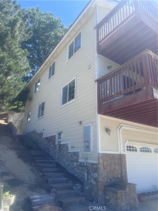 30134 Enchanted Way, Running Springs, CA 92382 - view of side of home featuring stone siding, stairway, and a balcony