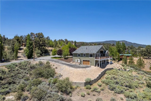 9401 Whispering Pines Rd, Frazier Park, CA 93225 - rear view of house with a wooden deck, an attached garage, and driveway