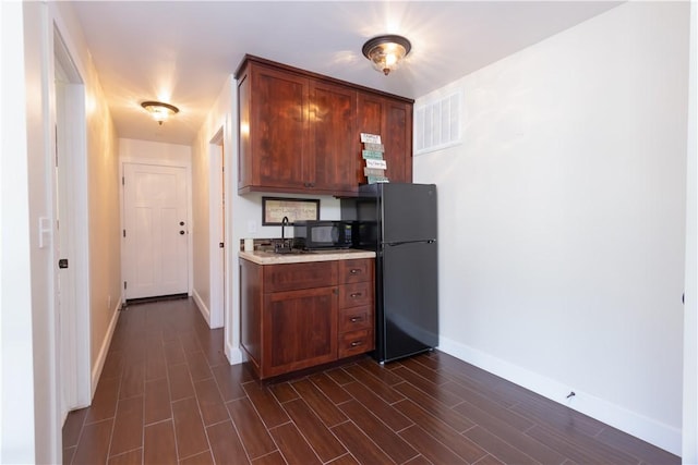 9401 Whispering Pines Rd, Frazier Park, CA 93225 - kitchen with black appliances, light countertops, and dark wood-type flooring