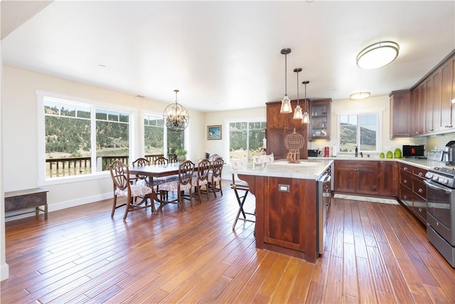 9401 Whispering Pines Rd, Frazier Park, CA 93225 - kitchen featuring stainless steel appliances, a chandelier, light countertops, dark wood-type flooring, and a kitchen island