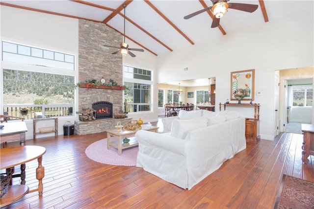 9401 Whispering Pines Rd, Frazier Park, CA 93225 - living room featuring ceiling fan, high vaulted ceiling, a stone fireplace, hardwood / wood-style floors, and plenty of natural light