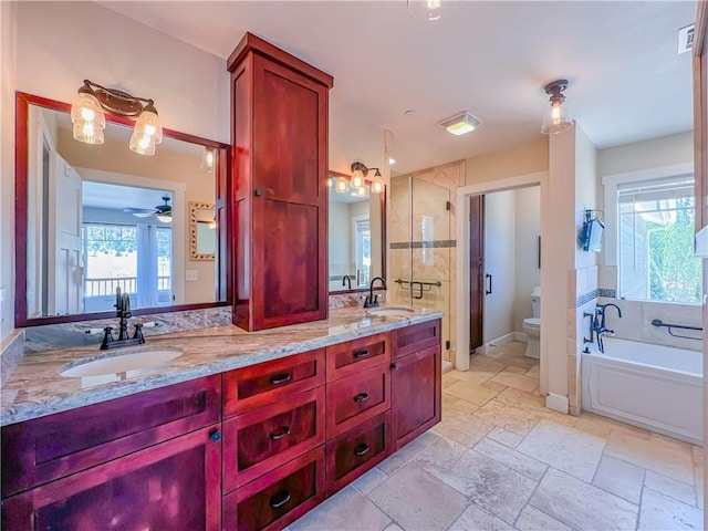 9401 Whispering Pines Rd, Frazier Park, CA 93225 - full bathroom featuring a bath, double vanity, stone tile flooring, and ceiling fan