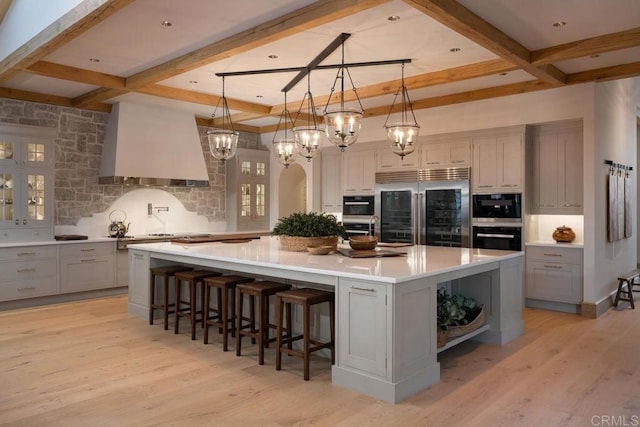 17845 Via De Fortuna, Rancho Santa Fe, CA 92067 - kitchen with stainless steel built in fridge, custom exhaust hood, coffered ceiling, gray cabinetry, and decorative backsplash