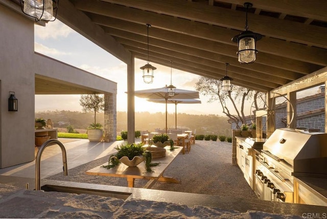 17845 Via De Fortuna, Rancho Santa Fe, CA 92067 - patio terrace at dusk featuring a patio, outdoor dining area, and an outdoor kitchen