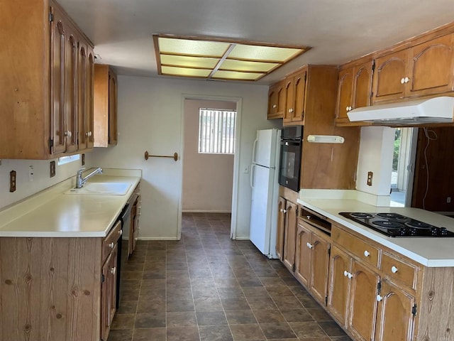 1110 E Alvarado St, Fallbrook, CA 92028 - kitchen with black appliances, under cabinet range hood, brown cabinetry, and light countertops